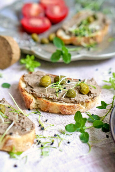 Turkey liver pâté served on toasted bread with capers and microgreens
