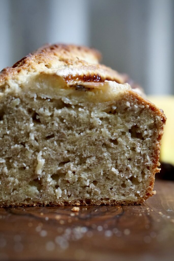 Close-up of a moist homemade banana bread slice showing its soft and tender crumb.