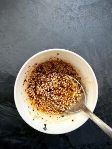 Homemade Oi Muchim dressing made with sesame oil, fish sauce, gochugaru, garlic, and toasted sesame seeds.