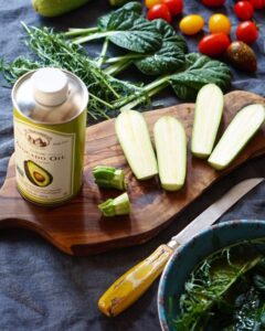 Zucchini sliced into large pieces with avocado oil, ready to grill for the salad