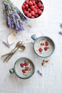 Creamy almond milk chia pudding served with fresh raspberries, coconut flakes, and chia seeds.