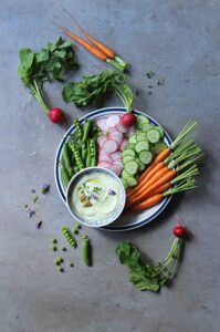 Fresh vegetable platter served with creamy avocado Greek yogurt dip.