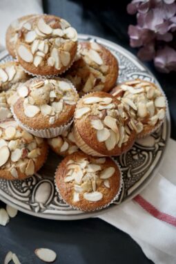 Close-up of cherry almond buttermilk muffins on a patterned plate
