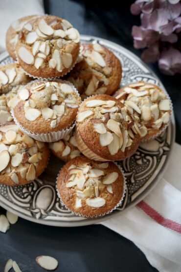 Close-up of cherry almond buttermilk muffins on a patterned plate
