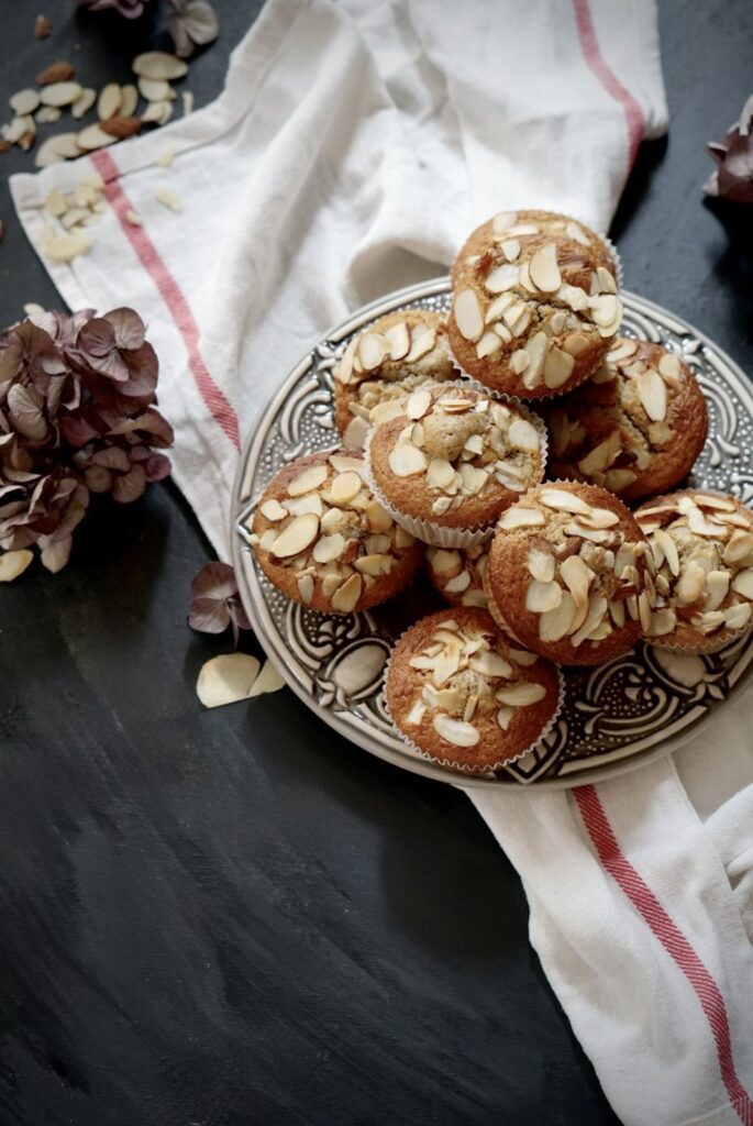 Plate of cherry buttermilk muffins with almond flour topped with sliced almonds