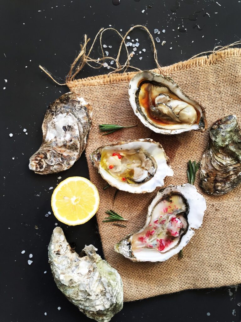 Three fresh oysters served with mignonette, lemon ginger, and soy lemon sauces