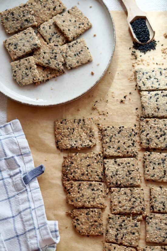 Homemade gluten-free almond flour crackers with white and black sesame seeds