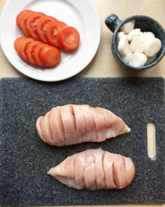 Step-by-step process of slicing crosswise cuts into raw chicken breast for Hasselback recipe