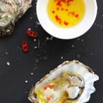 Fresh oyster with homemade lemon ginger sauce and red chili