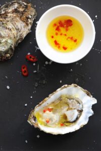 Fresh oyster with homemade lemon ginger sauce and red chili