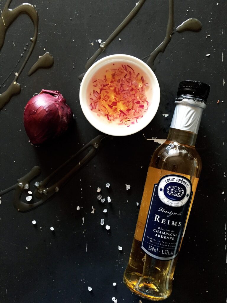 Ingredients for mignonette sauce: red onion and white wine vinegar