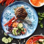 Pan-seared bone-in steak served with a rainbow vegetable salad