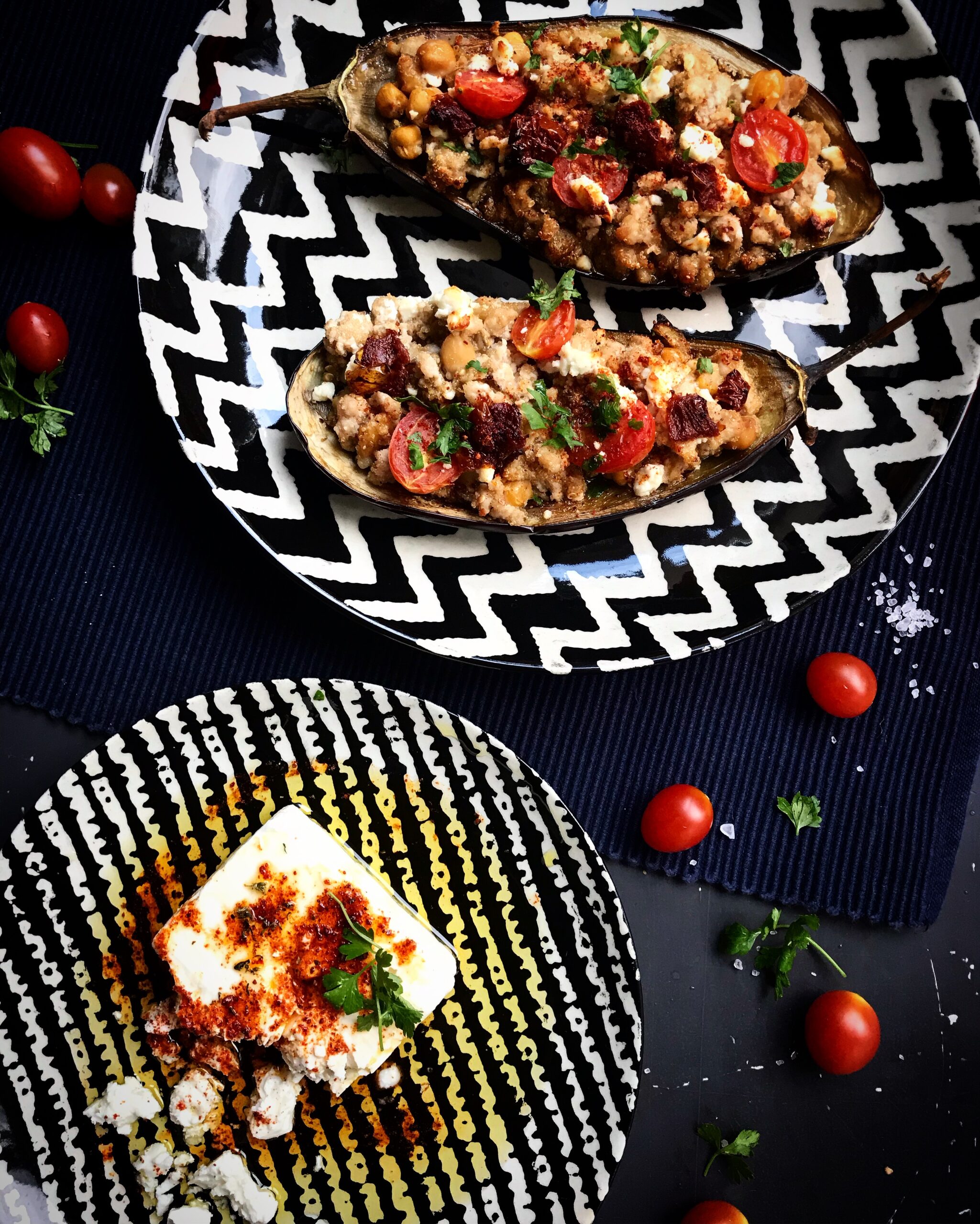 Baked eggplant boats stuffed with ground beef, chickpeas, cherry tomatoes, and crumbled feta cheese