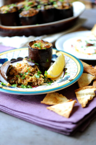 Stuffed eggplant with ground beef served with yogurt, lemon, and crispy pita wedges