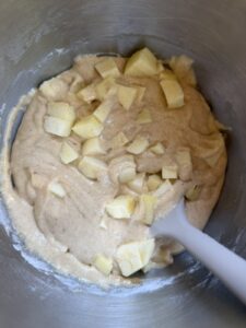 Apple bread batter with chunks of fresh apples folded into the mixture