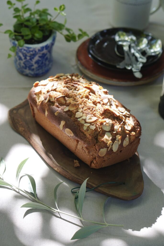 Homemade apple bread topped with sliced almonds and filled with fresh apple pieces