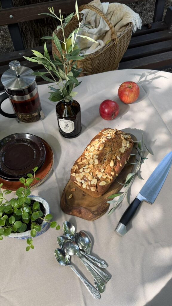 Homemade apple cinnamon bread loaf topped with sliced almonds