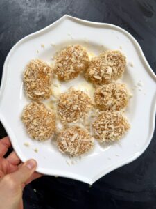 A plate of fully breaded ground chicken nuggets ready for the skillet.