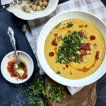 Creamy green lentil soup with chickpeas, parsley, and harissa