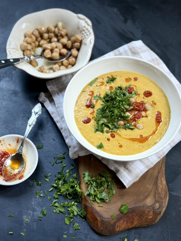 Creamy green lentil soup drizzled with harissa oil