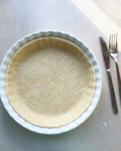 Docked shortcrust pastry crust pricked with a fork before baking