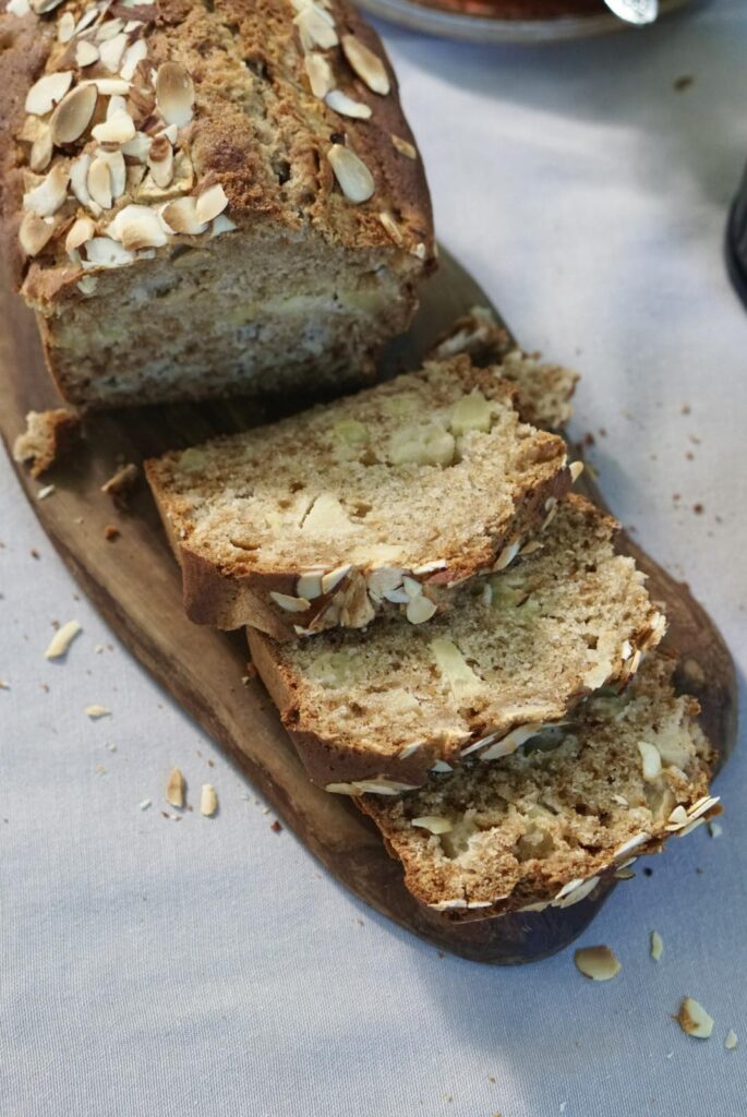 Sliced homemade apple bread with fresh apples and cinnamon