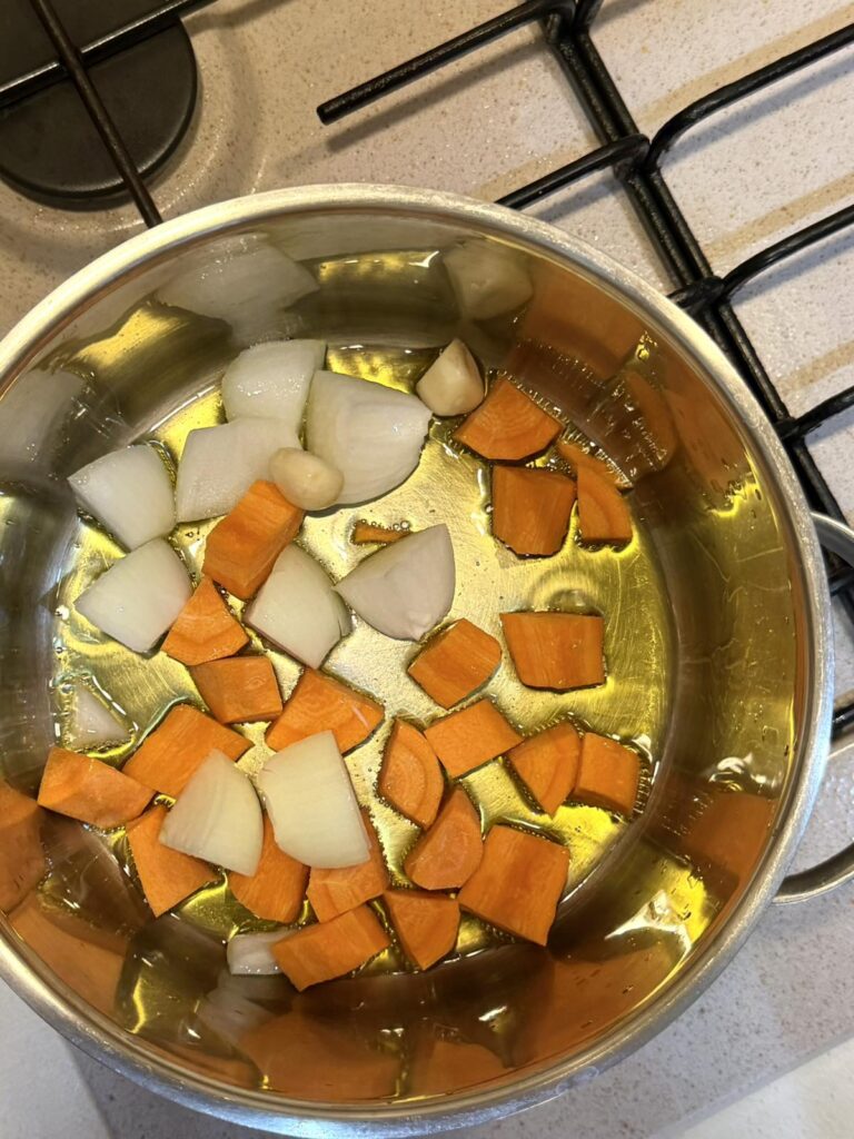 Carrots, onion, and garlic sautéing in olive oil